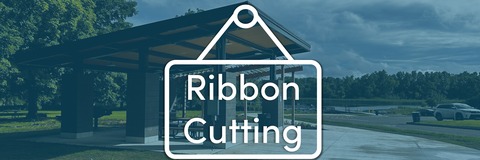 New pavilion with accessible pathway down to boat launch and accessible fishing pier with overlaid Ribbon Cutting banner