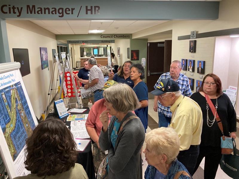 Public engagement event in a crowded hallway at City Hall